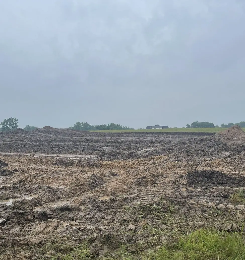 Large site stripped to bare dirt on a grey day