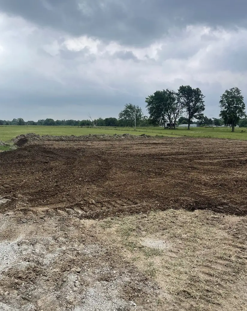Freshly cut pad of dirt and rock under a cloudy sky